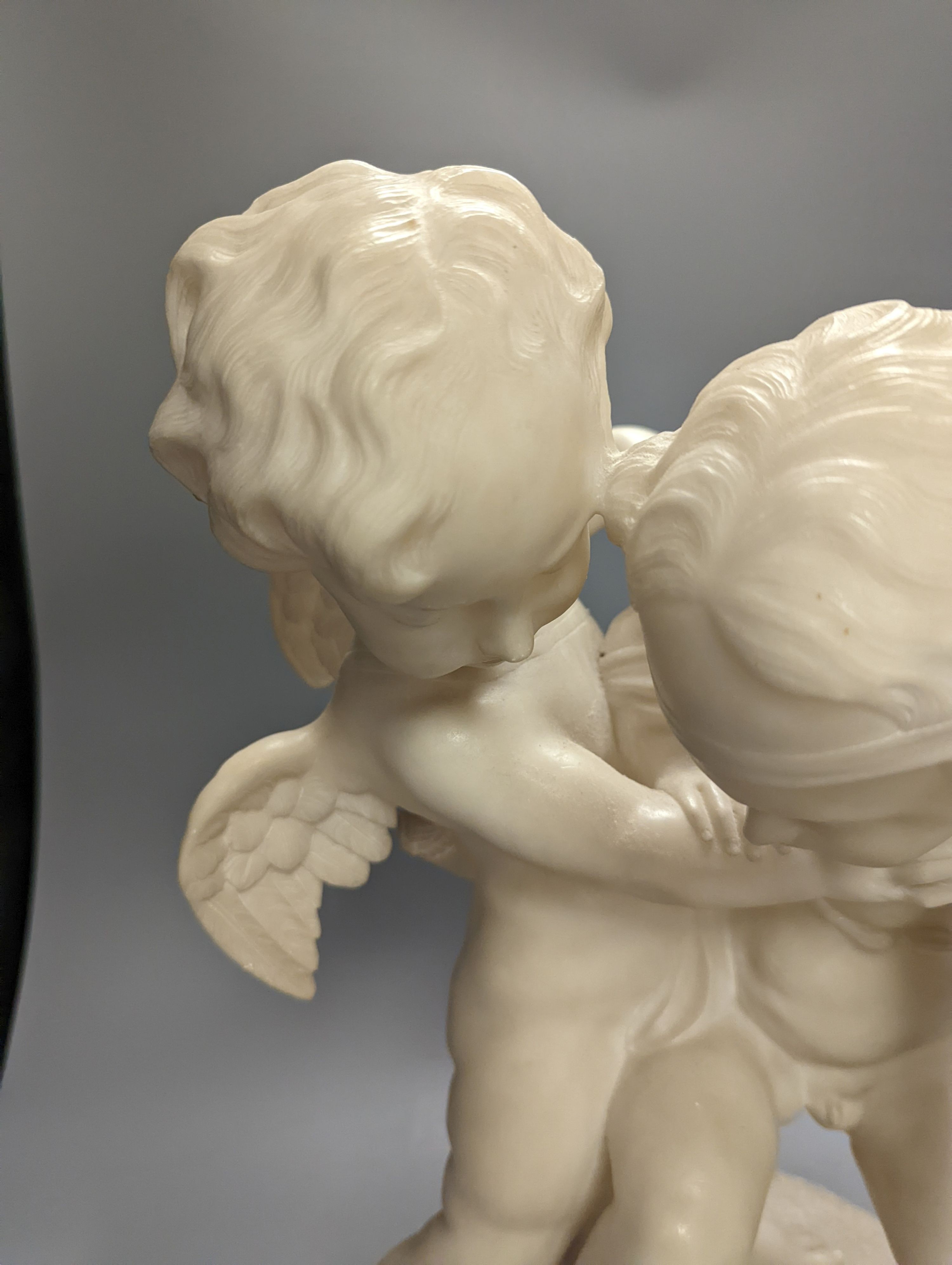 An early 20th century Italian carved alabaster cherub group, height 45cm